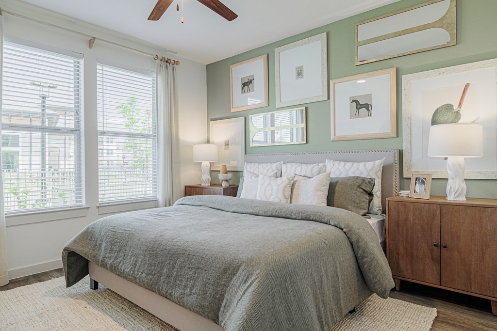 a bedroom with a bed and a ceiling fan