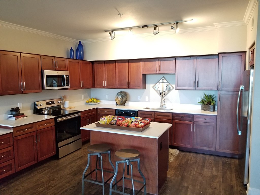 a kitchen with a center island with two stools in front of it