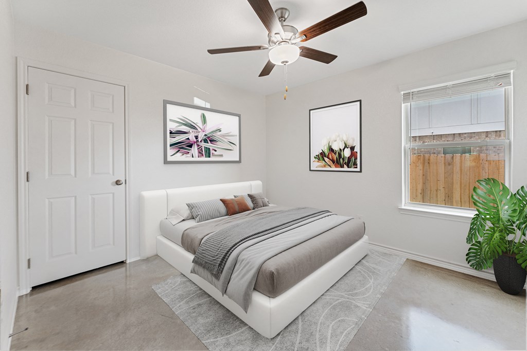 a bedroom with a bed and a ceiling fan