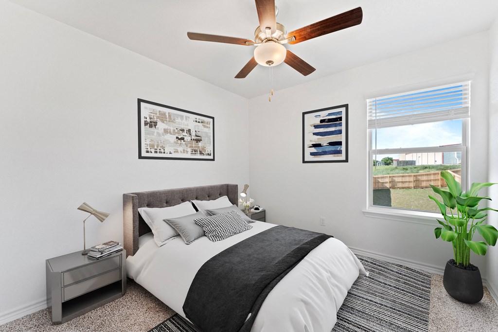 a bedroom with a large bed and a ceiling fan
