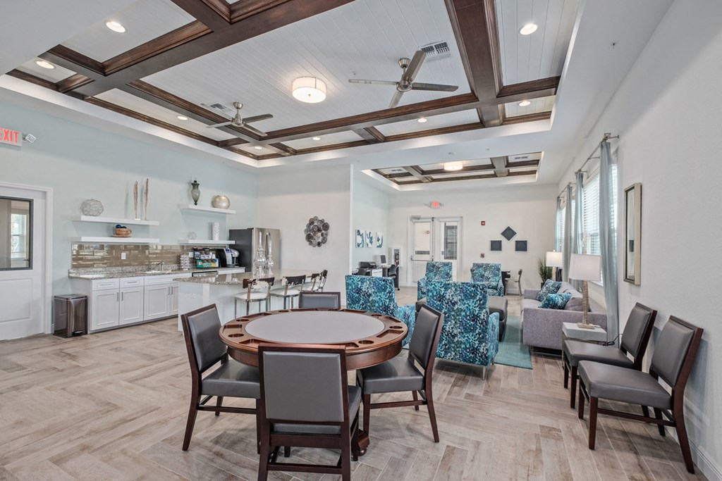 a dining room with a table and chairs and a kitchen