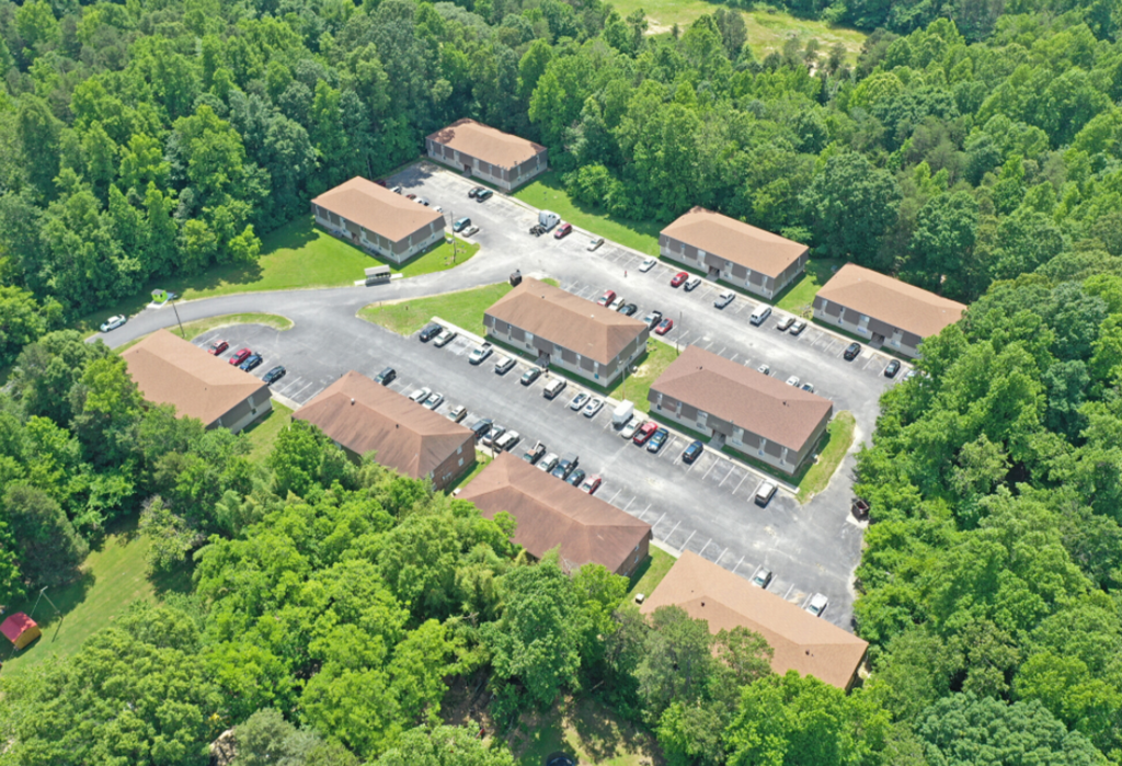 an aerial view of a parking lot and several buildings