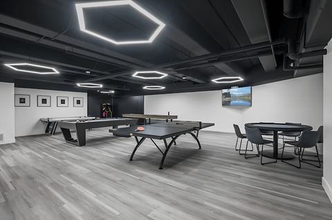 A room with a pool table and a ping pong table.