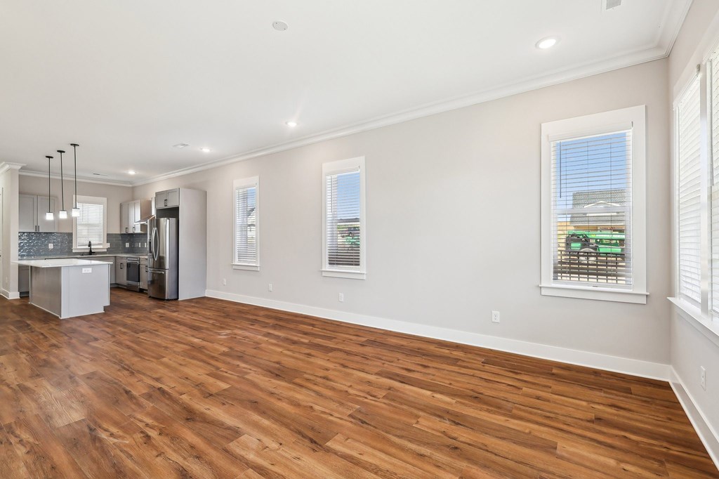 A kitchen with a refrigerator, stove, and oven.