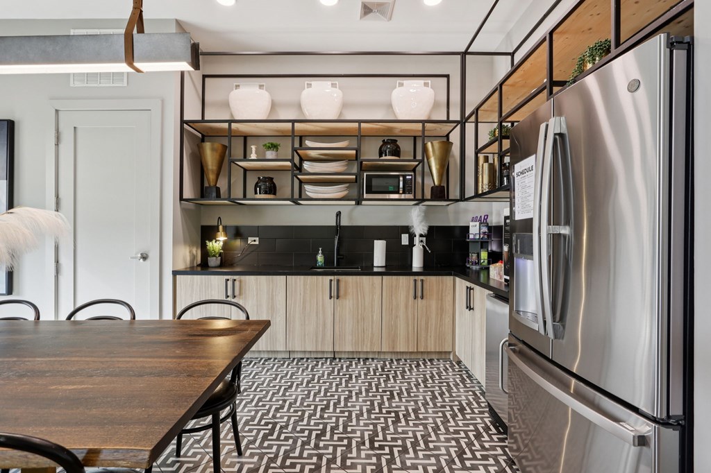 A modern kitchen with a wooden table and stainless steel appliances.