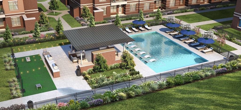 an aerial view of a swimming pool in a backyard with a pool house and lawn