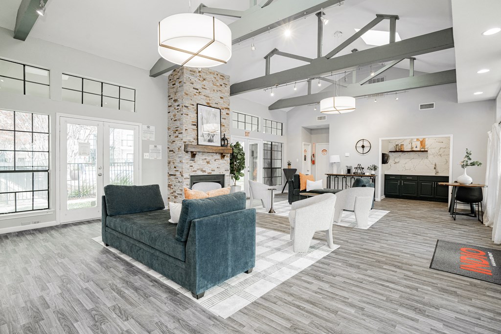 a living room with couches and chairs and a fireplace