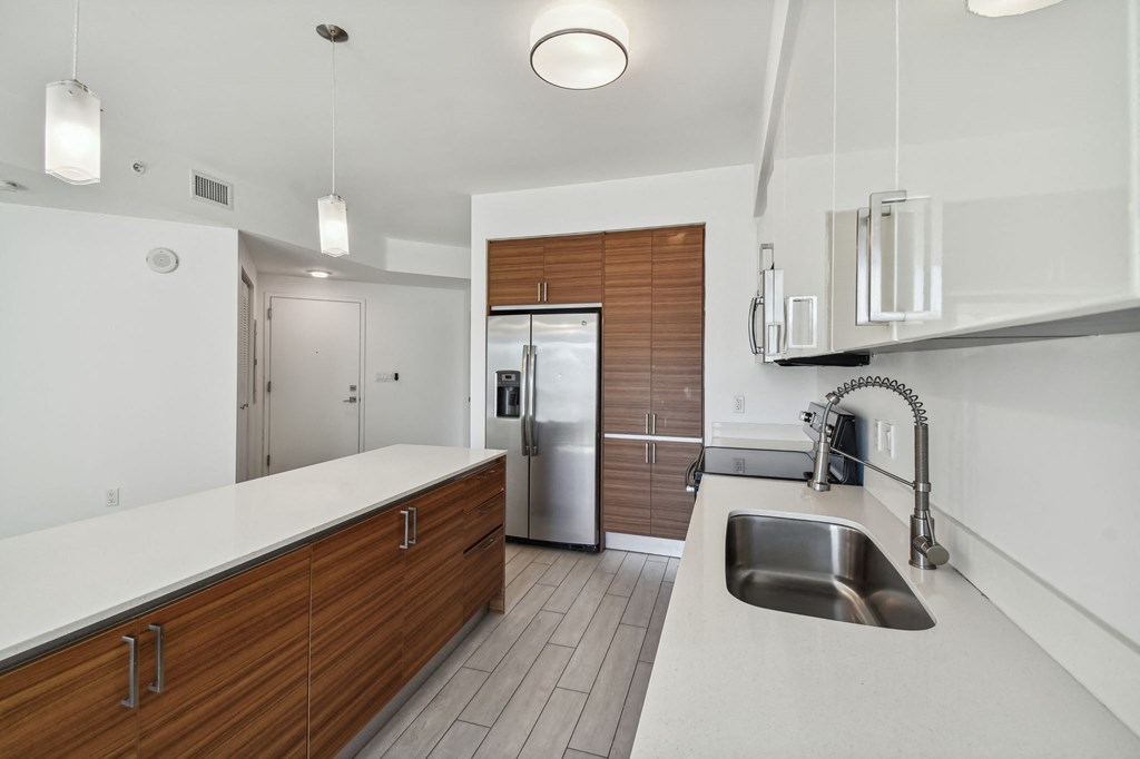 a kitchen with white countertops and wooden cabinets