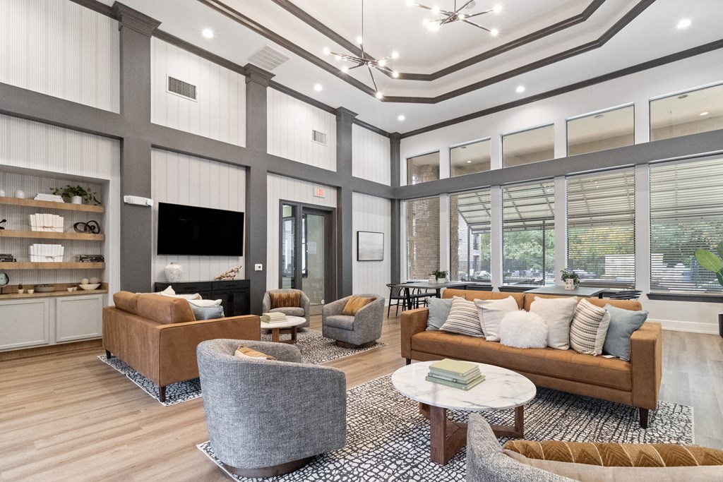 a living room with couches and chairs and a tv