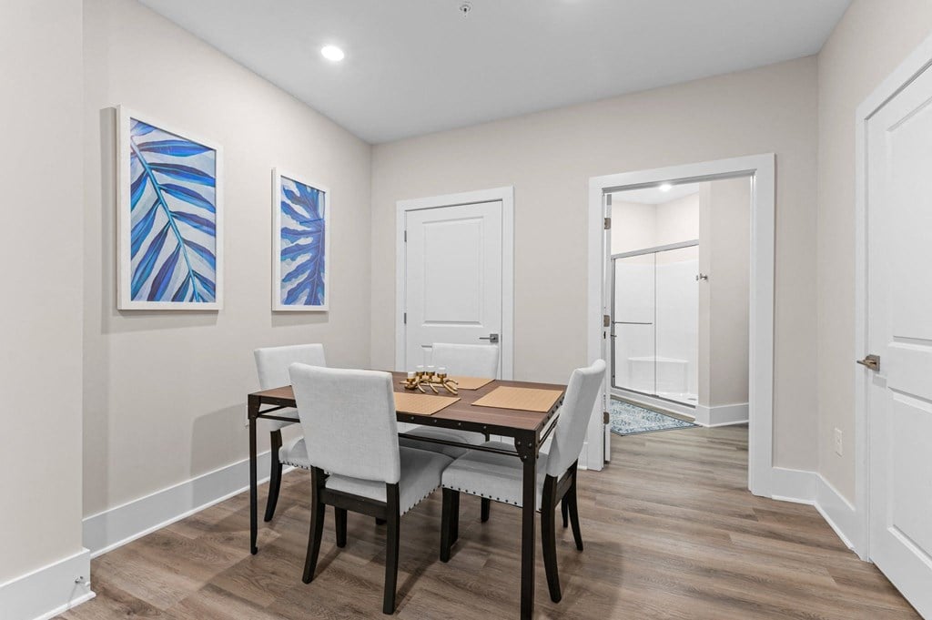a dining room with a wooden table and chairs