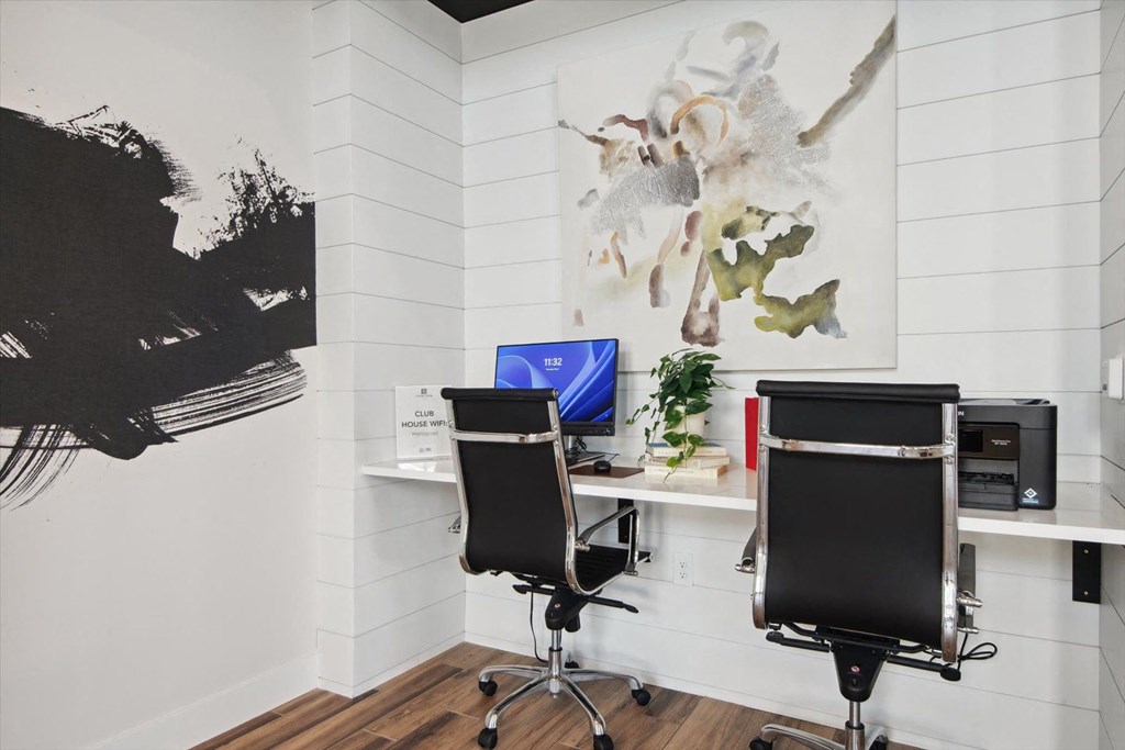 a room filled with desks and chairs and a wall with spikes on it