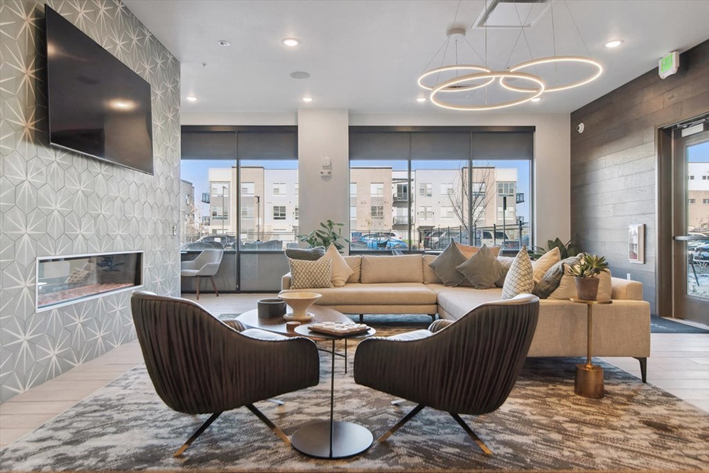 A modern living room with a fireplace and a large window.