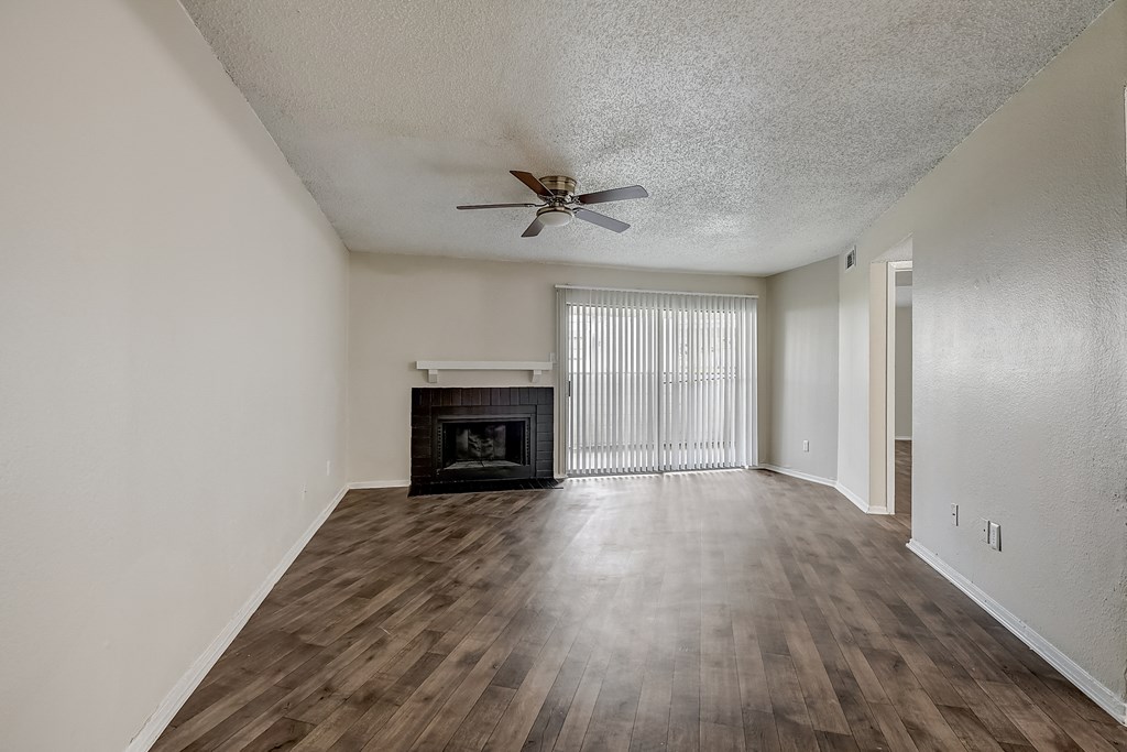 a living room with hardwood floors and a fireplace
