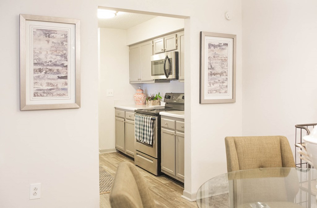 a kitchen with stainless steel appliances and a glass table