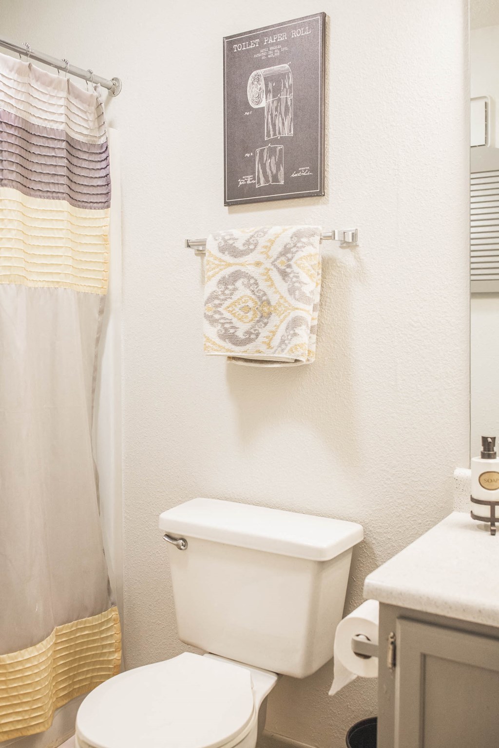 a small bathroom with a white toilet and a shower curtain
