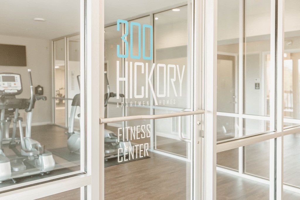 a gym with a sign in the window that reads 300 hickory fitness center