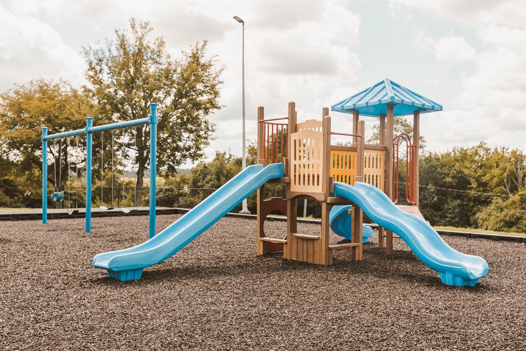 a playground with a slide at a park