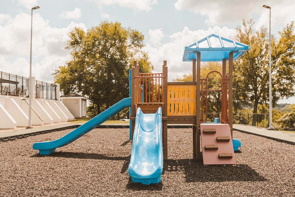 a playground with a swing set and a slide
