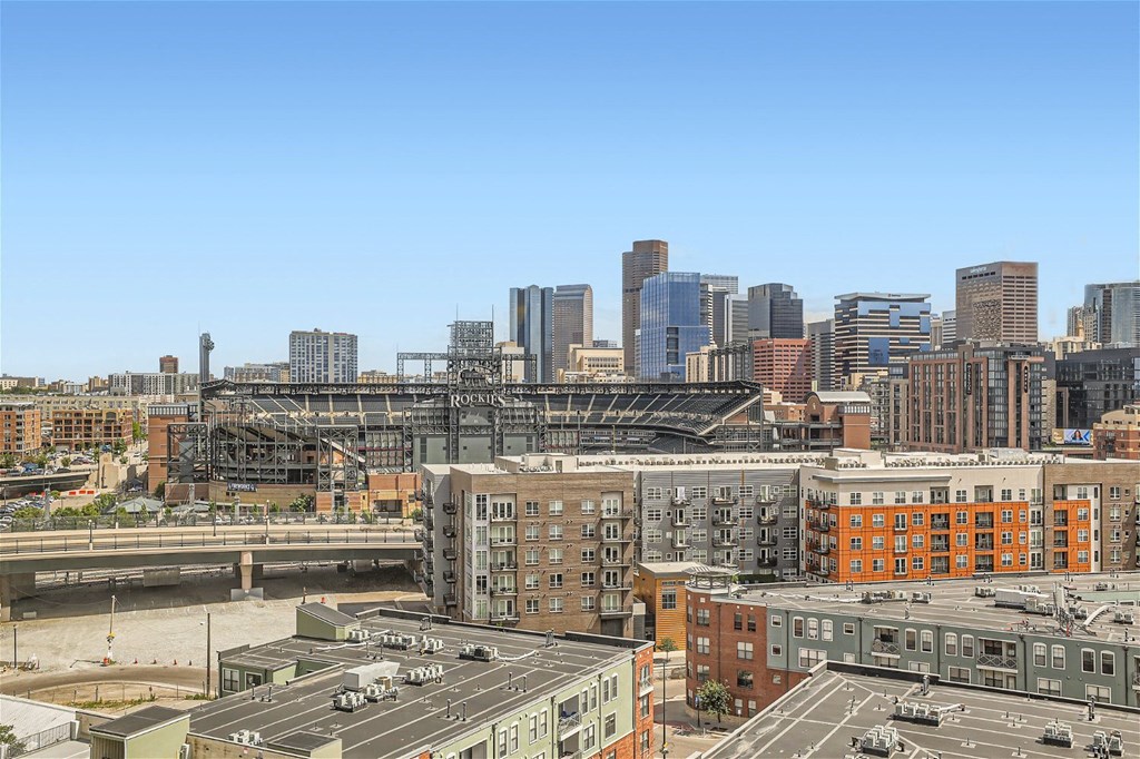 the skyline of the city with a bridge in the foreground and buildings