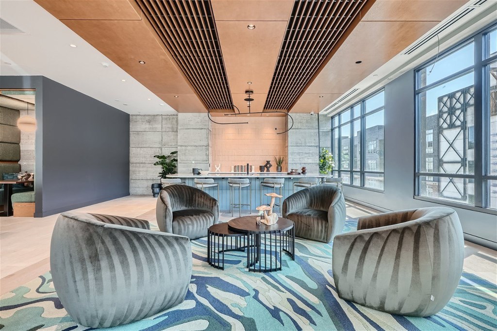 a lounge area with chairs and a bar in a lobby