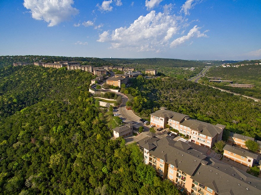 an aerial view of a city with trees and buildings