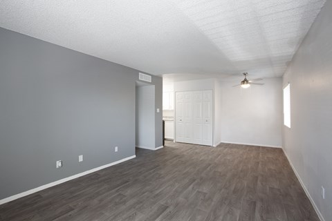 A room with a ceiling fan and a door.