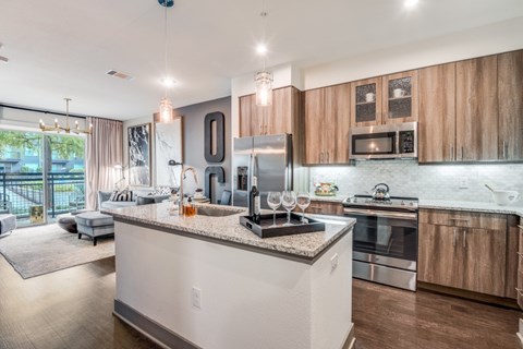 A modern kitchen with wooden cabinets and stainless steel appliances.