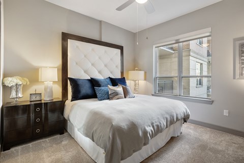 a bedroom with a large bed and a window