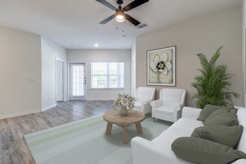 an open living room with white furniture and a ceiling fan