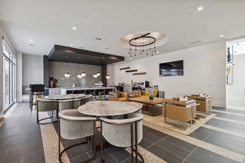 A modern dining room with a large table and chairs.