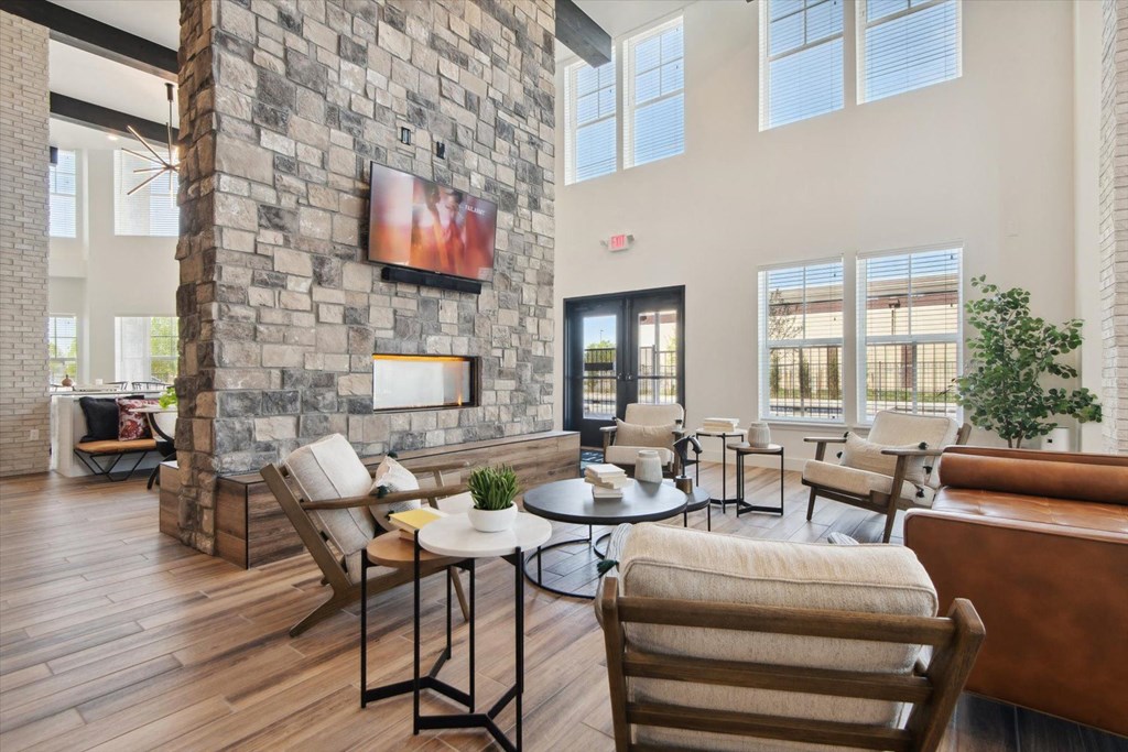 a living room with a stone fireplace and furniture