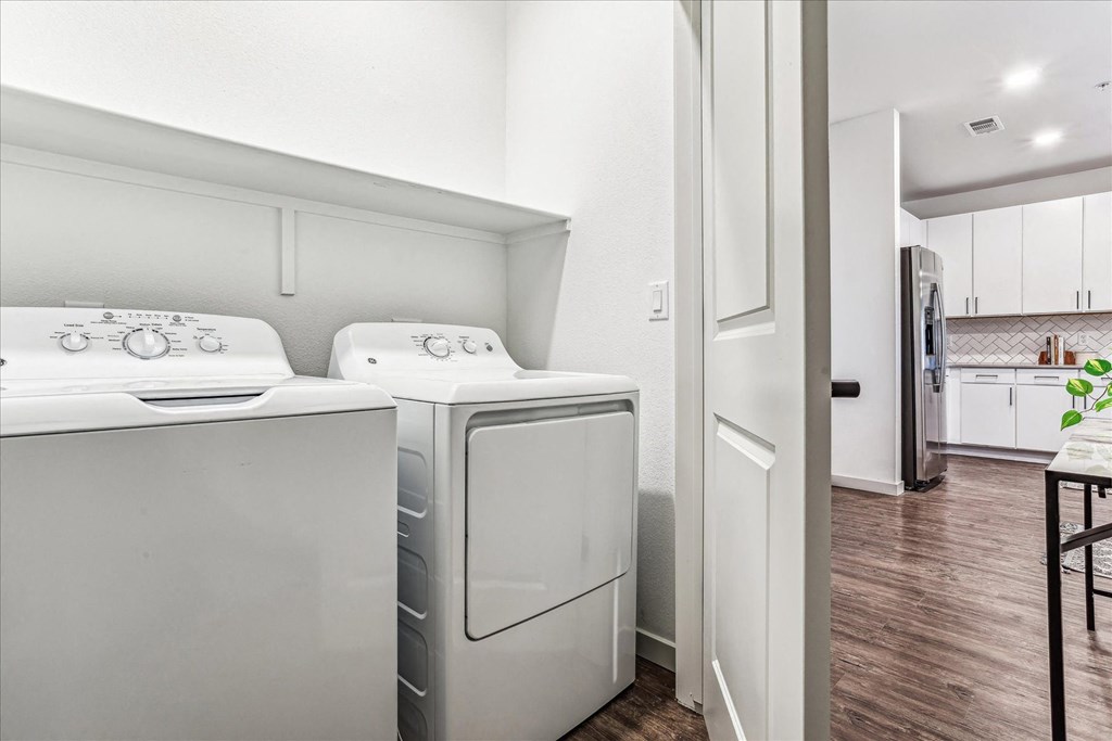 a washer and dryer in a laundry room with a kitchen