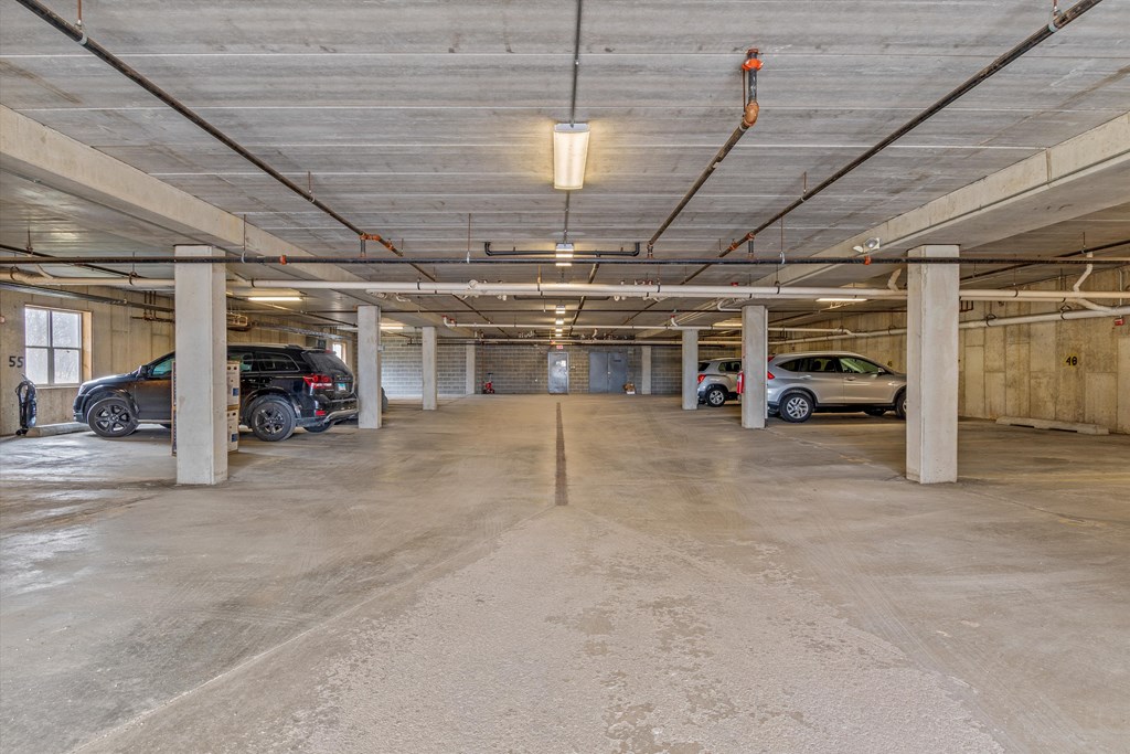an empty parking garage with cars parked in it