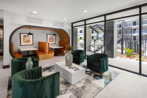 A modern living room with a green chair and a white coffee table.