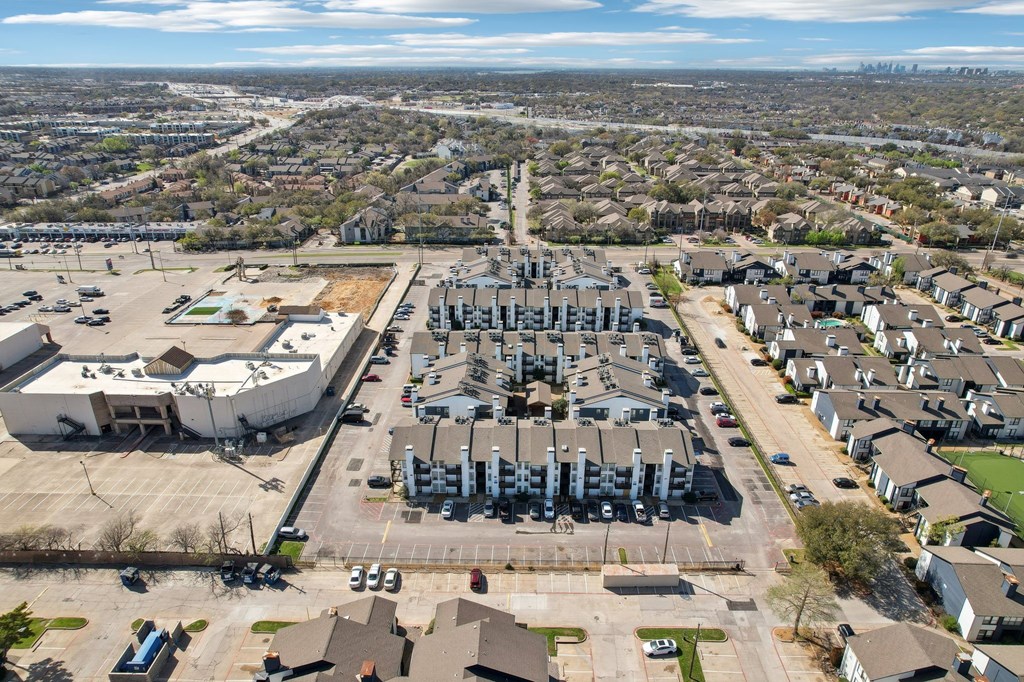 A large industrial complex is surrounded by apartment buildings.