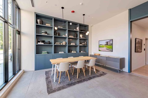 A modern dining room with a wooden table and chairs.