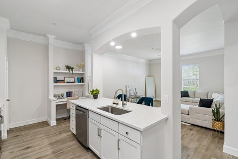 A modern kitchen with white cabinets and a large island.