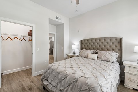 A bedroom with a large bed and a dresser.