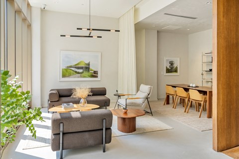 A living room with a grey couch and a wooden coffee table.