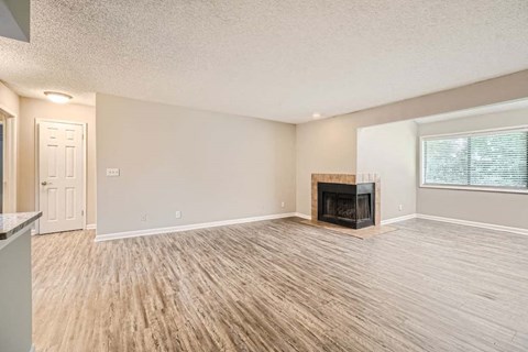A living room with a fireplace and hardwood floors.