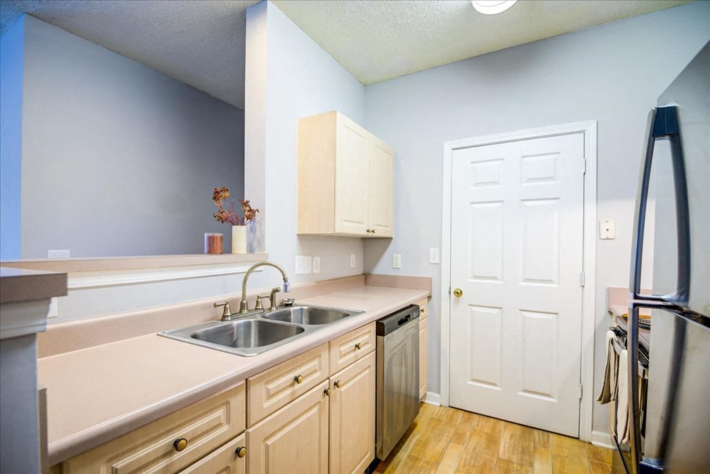 a kitchen with a sink and a refrigerator