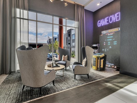 A modern lounge area with a large screen displaying the words