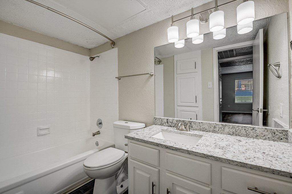 a bathroom with a sink toilet and bathtub