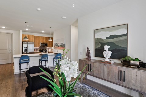 A kitchen with a bar and a painting on the wall.
