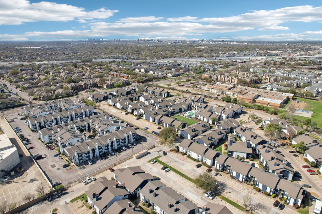 A bird's eye view of a residential area with houses and cars.