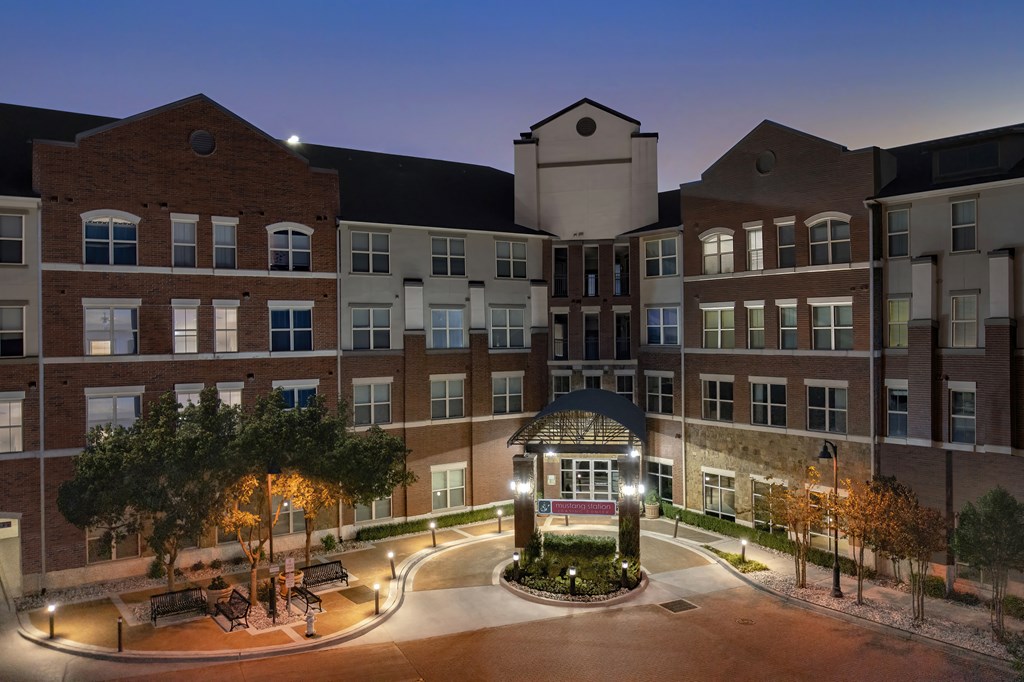a large building with a fountain at night