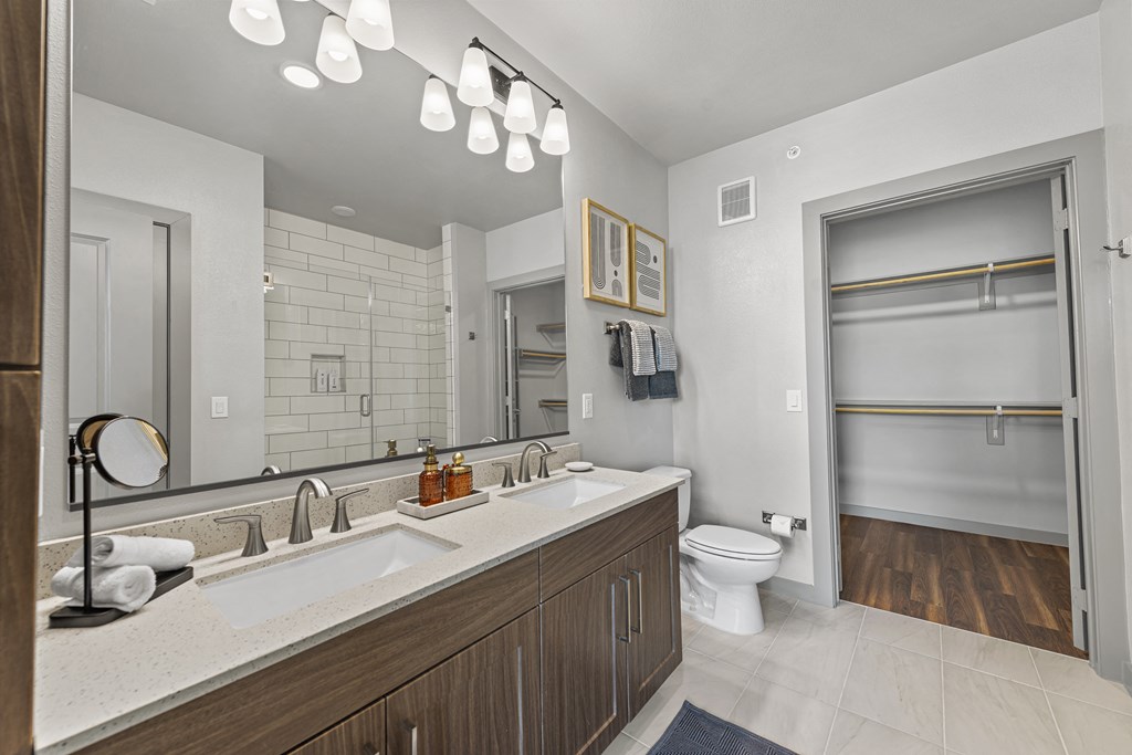 a bathroom with a sink and a toilet and a mirror