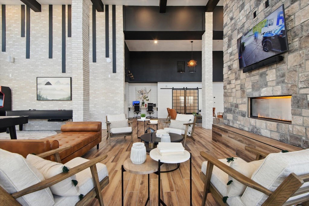 a living room with couches and chairs and a fireplace