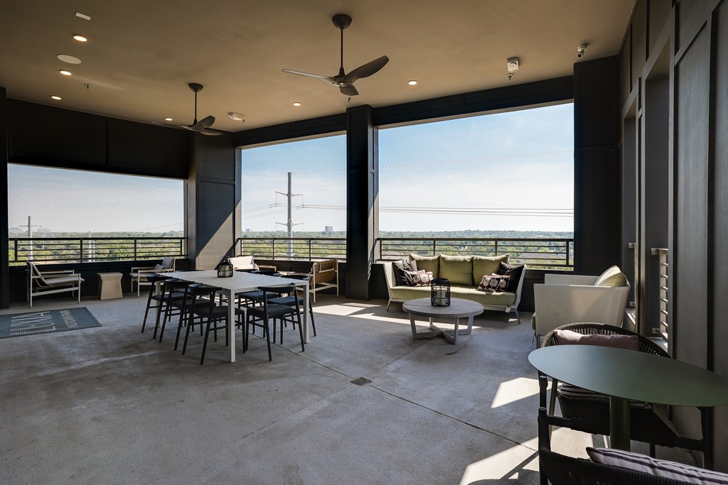 A patio with a table and chairs overlooking the ocean.
