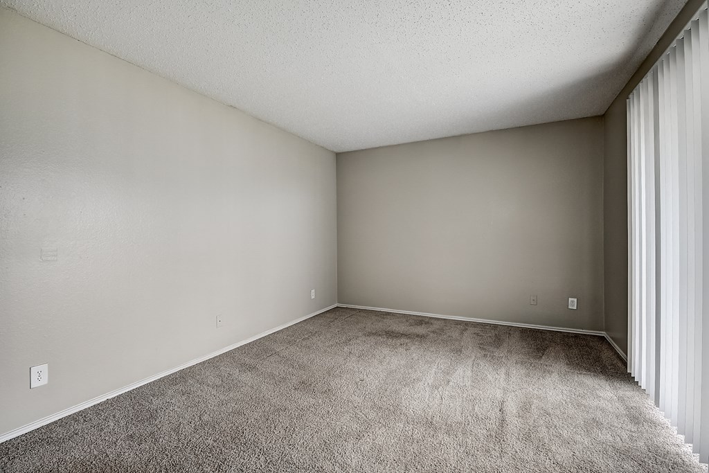 a bedroom with gray walls and a carpeted floor